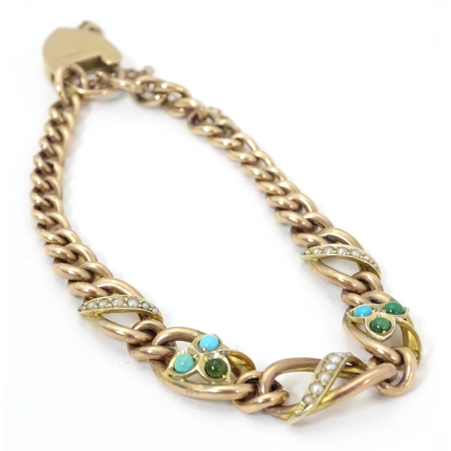 629 - A 9ct gold bracelet set with seed pearl and turquoise in a shamrock setting