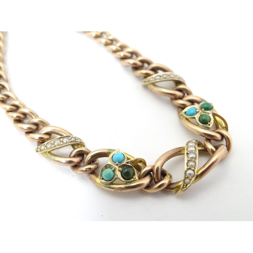 629 - A 9ct gold bracelet set with seed pearl and turquoise in a shamrock setting