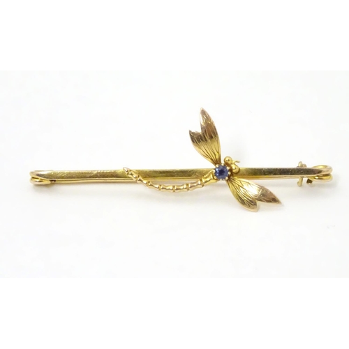 630 - A 9ct gold bar brooch with dragon fly detail set with sapphire to body 2 3/4