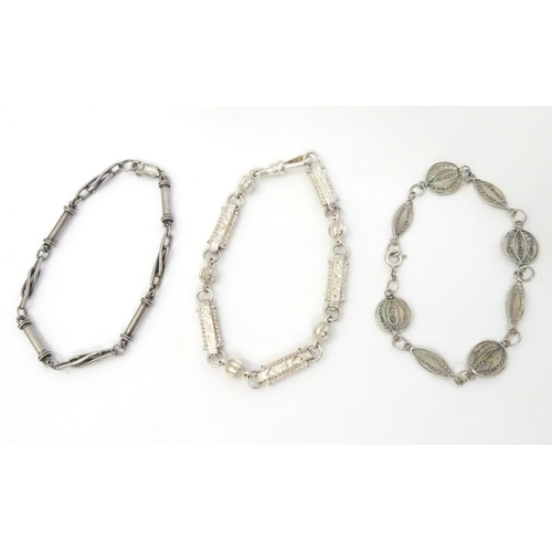 639 - Three assorted silver and white metal bracelets including one with filigree decoration. (3)