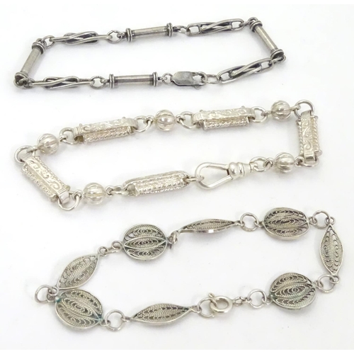 639 - Three assorted silver and white metal bracelets including one with filigree decoration. (3)