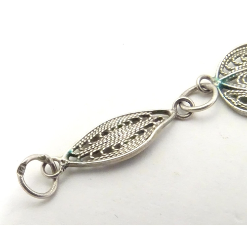 639 - Three assorted silver and white metal bracelets including one with filigree decoration. (3)