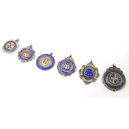 648 - An assortment of early 20thC hallmarked silver fob medals, each obverse with enamelled insignia, the... 