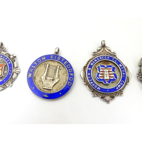 648 - An assortment of early 20thC hallmarked silver fob medals, each obverse with enamelled insignia, the... 