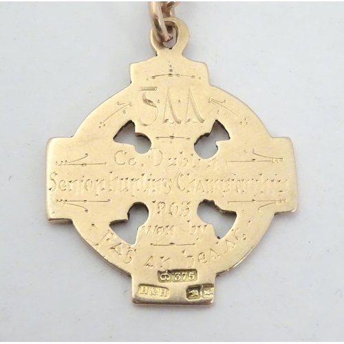 652 - Irish Hurling winner's gold medal: an early 20thC 9ct gold medal formed as a celtic ringed cross, th... 