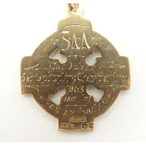 652 - Irish Hurling winner's gold medal: an early 20thC 9ct gold medal formed as a celtic ringed cross, th... 