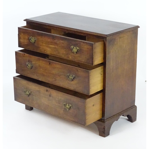 1382 - A late 18thC / early 19thC mahogany chest of drawers with a moulded rectangular top above three long... 