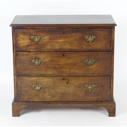 1382 - A late 18thC / early 19thC mahogany chest of drawers with a moulded rectangular top above three long... 