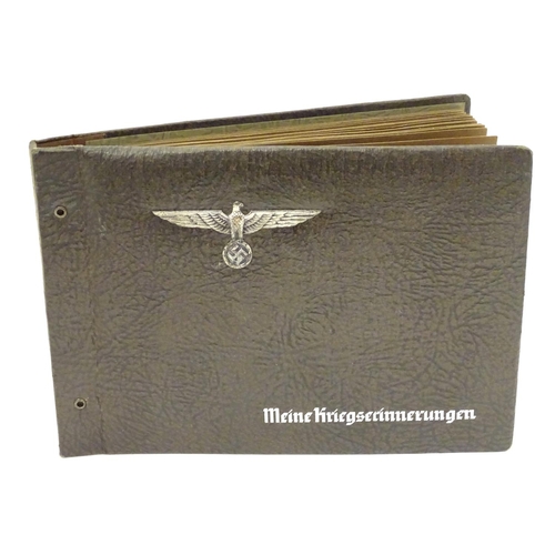 672 - Militaria: a WWII/WW2/Second World War German photograph album, the cover with Reichsadler, titled '... 