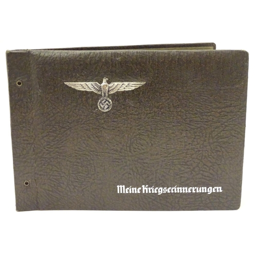 672 - Militaria: a WWII/WW2/Second World War German photograph album, the cover with Reichsadler, titled '... 