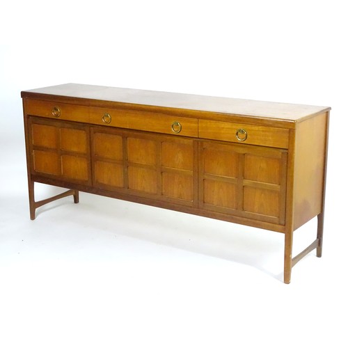 1566 - Vintage retro, mid-century: a 1970s teak sideboard by Nathan Furniture, composed of three cupboards ... 