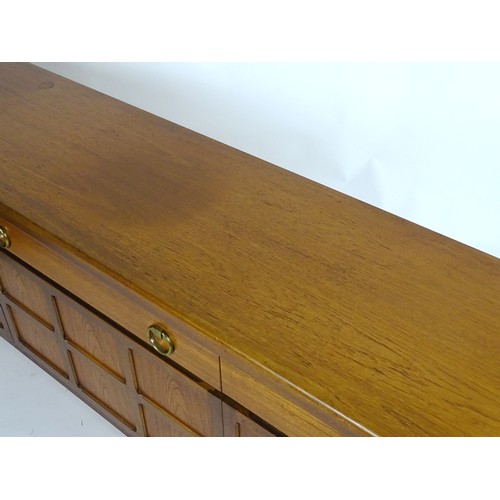 1566 - Vintage retro, mid-century: a 1970s teak sideboard by Nathan Furniture, composed of three cupboards ... 