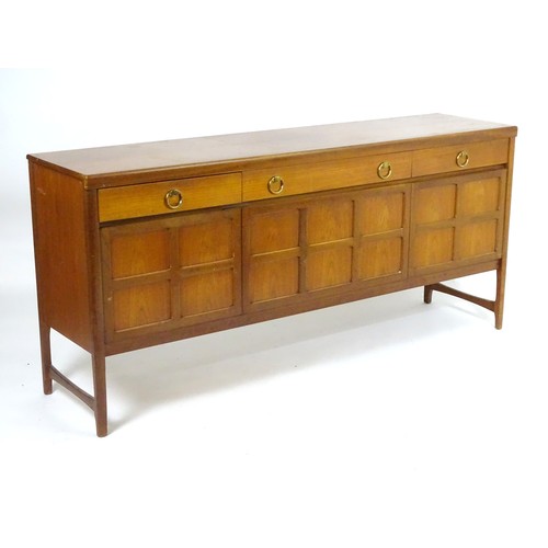 1566 - Vintage retro, mid-century: a 1970s teak sideboard by Nathan Furniture, composed of three cupboards ... 