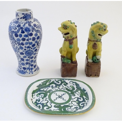 12 - A quantity of Oriental items comprising a blue and white vase decorated with dragons amongst flowers... 