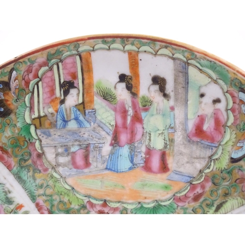 36 - A Chinese Cantonese famille rose plate with panelled decoration depicting figures on a terrace, and ... 