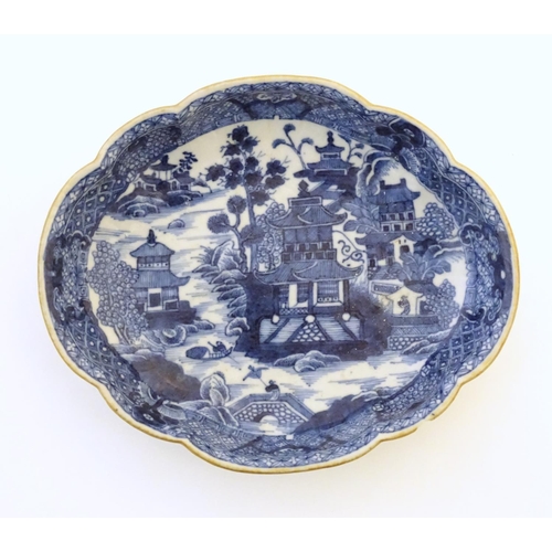 44 - An Oriental blue and white plate with stylised peony detail, and stylised scrolling flower motifs to... 