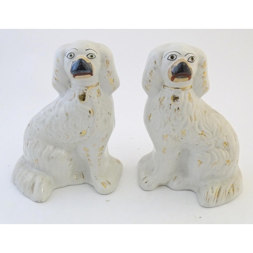 60 - A pair of Staffordshire pottery spaniel dogs with gilt highlights. Approx. 10