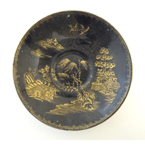 273 - A Booths Silicon China tea cup and saucer, together with two small plates with a black ground and gi... 