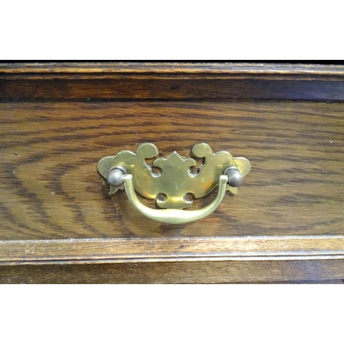 7 - A two over three oak chest of drawers with geometric decoration
