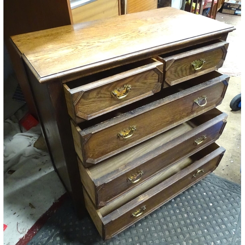 7 - A two over three oak chest of drawers with geometric decoration