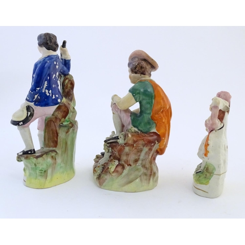 67 - Five assorted Staffordshire pottery figures comprising two models of shepherds and their sheep, two ... 