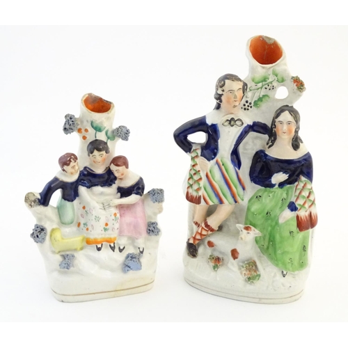 67 - Five assorted Staffordshire pottery figures comprising two models of shepherds and their sheep, two ... 