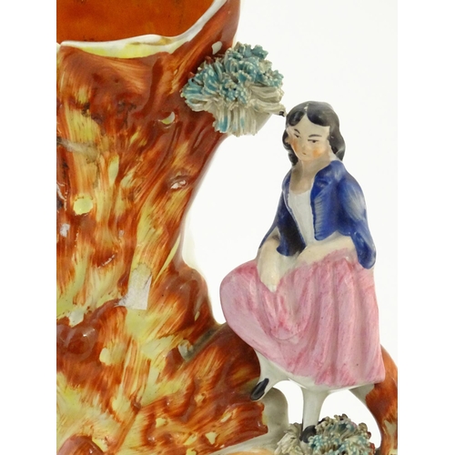 70 - A Staffordshire pottery flat back bud vase depicting a girl on a bridge next to a tree with a fox st... 