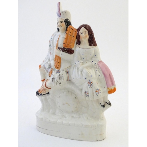 71 - A Staffordshire flat back figural group depicting a Scottish highland couple with clock detail below... 