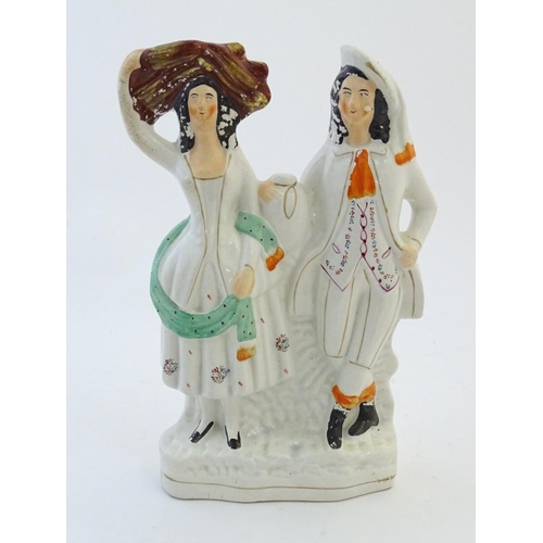 72 - A Staffordshire pottery flat back figural group depicting a harvest couple, the man carries a flagon... 