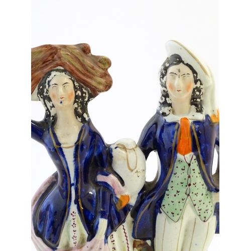 75 - A Staffordshire pottery flat back figural group depicting a harvest couple, the man carries a flagon... 