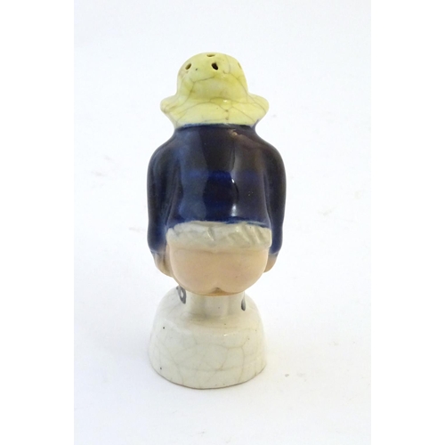 78 - An early 19thC Staffordshire comical / novelty pepper pot modelled as Roger Giles squatting. Approx.... 