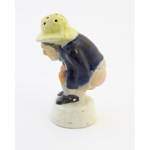 78 - An early 19thC Staffordshire comical / novelty pepper pot modelled as Roger Giles squatting. Approx.... 