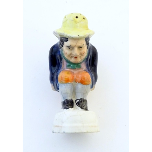 78 - An early 19thC Staffordshire comical / novelty pepper pot modelled as Roger Giles squatting. Approx.... 