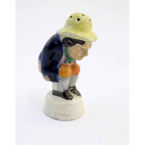 78 - An early 19thC Staffordshire comical / novelty pepper pot modelled as Roger Giles squatting. Approx.... 