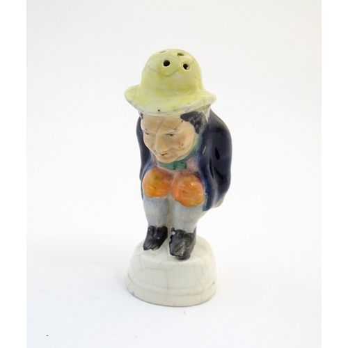 78 - An early 19thC Staffordshire comical / novelty pepper pot modelled as Roger Giles squatting. Approx.... 