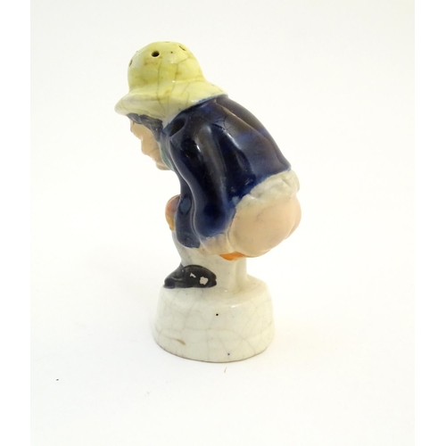 78 - An early 19thC Staffordshire comical / novelty pepper pot modelled as Roger Giles squatting. Approx.... 