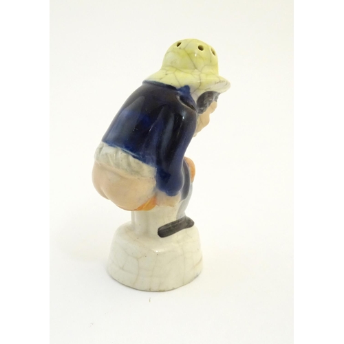 78 - An early 19thC Staffordshire comical / novelty pepper pot modelled as Roger Giles squatting. Approx.... 