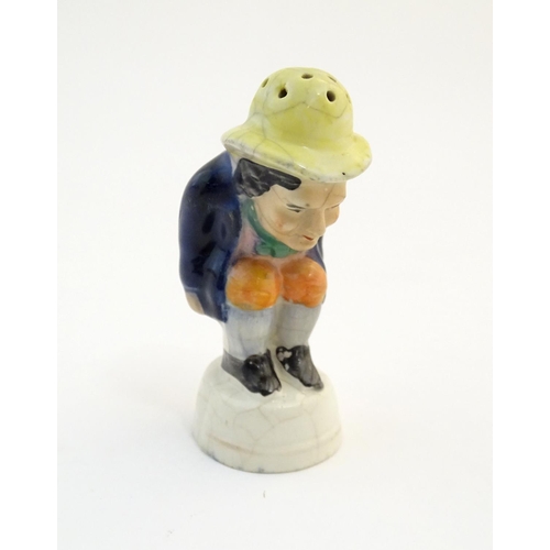 78 - An early 19thC Staffordshire comical / novelty pepper pot modelled as Roger Giles squatting. Approx.... 