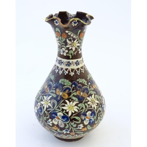 102 - A 19thC Swiss Thoune style vase with a fluted rim and flower decoration. Approx. 10 1/4