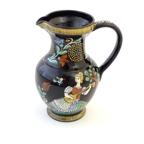 103 - A 19thC Swiss Thoune style jug decorated with a girl and a boy playing musical instruments in a land... 