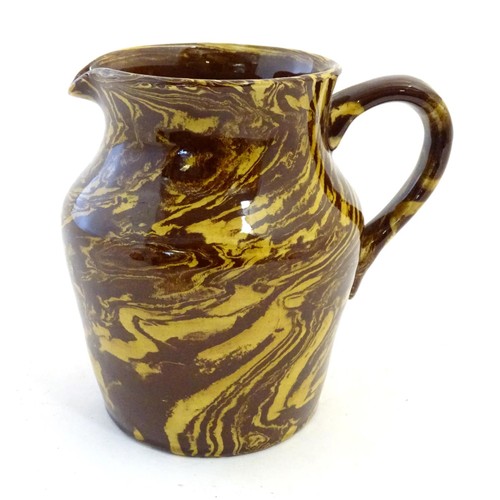 106 - A Price Brothers jug decorated in the agate ware style. Marked under. Approx. 6 1/2