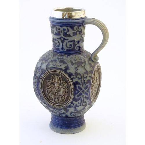 113 - A 19thC German salt glazed stoneware jug by Merkelbach & Wick, with a silver rim hallmarked Sheffiel... 