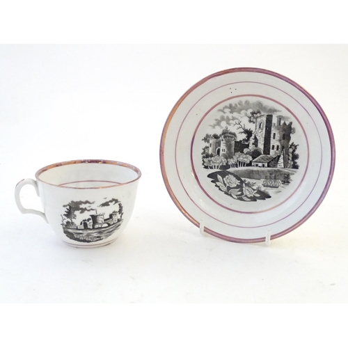 118 - A tea cup and saucer with monochrome transfer decoration depicting a river landscape with a ship and... 