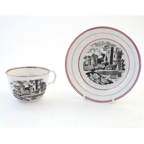 118 - A tea cup and saucer with monochrome transfer decoration depicting a river landscape with a ship and... 