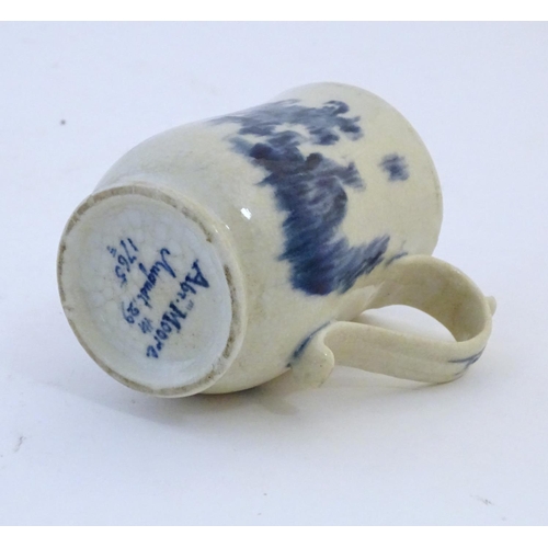 123 - A late 19th / early 20thC French copy of an Abraham Moore Lowestoft blue and white mug with floral d... 