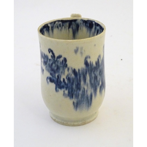 123 - A late 19th / early 20thC French copy of an Abraham Moore Lowestoft blue and white mug with floral d... 