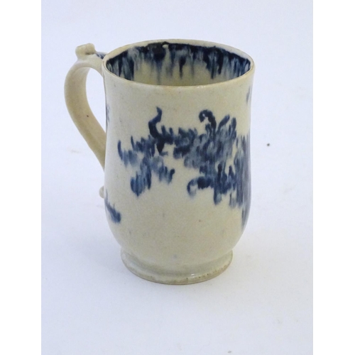 123 - A late 19th / early 20thC French copy of an Abraham Moore Lowestoft blue and white mug with floral d... 