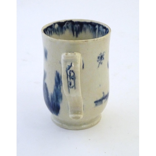 123 - A late 19th / early 20thC French copy of an Abraham Moore Lowestoft blue and white mug with floral d... 