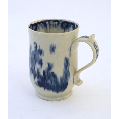 123 - A late 19th / early 20thC French copy of an Abraham Moore Lowestoft blue and white mug with floral d... 