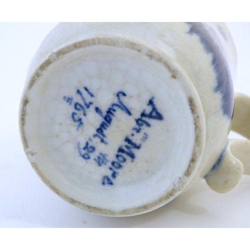 123 - A late 19th / early 20thC French copy of an Abraham Moore Lowestoft blue and white mug with floral d... 